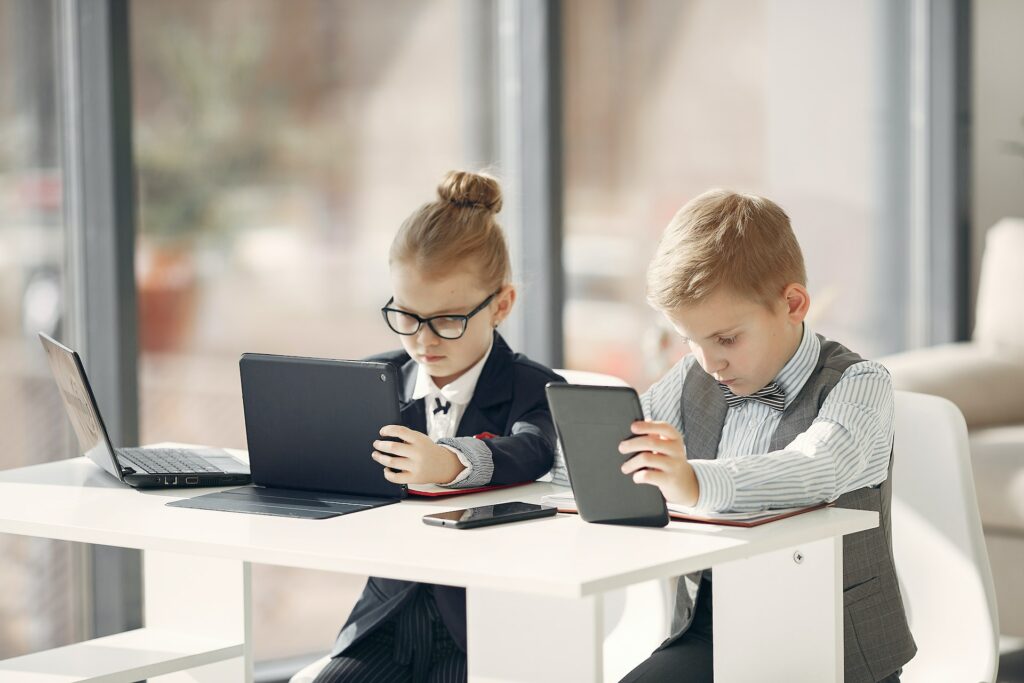 Two children playing pretending to work, play is another great way to introduce career paths to young children