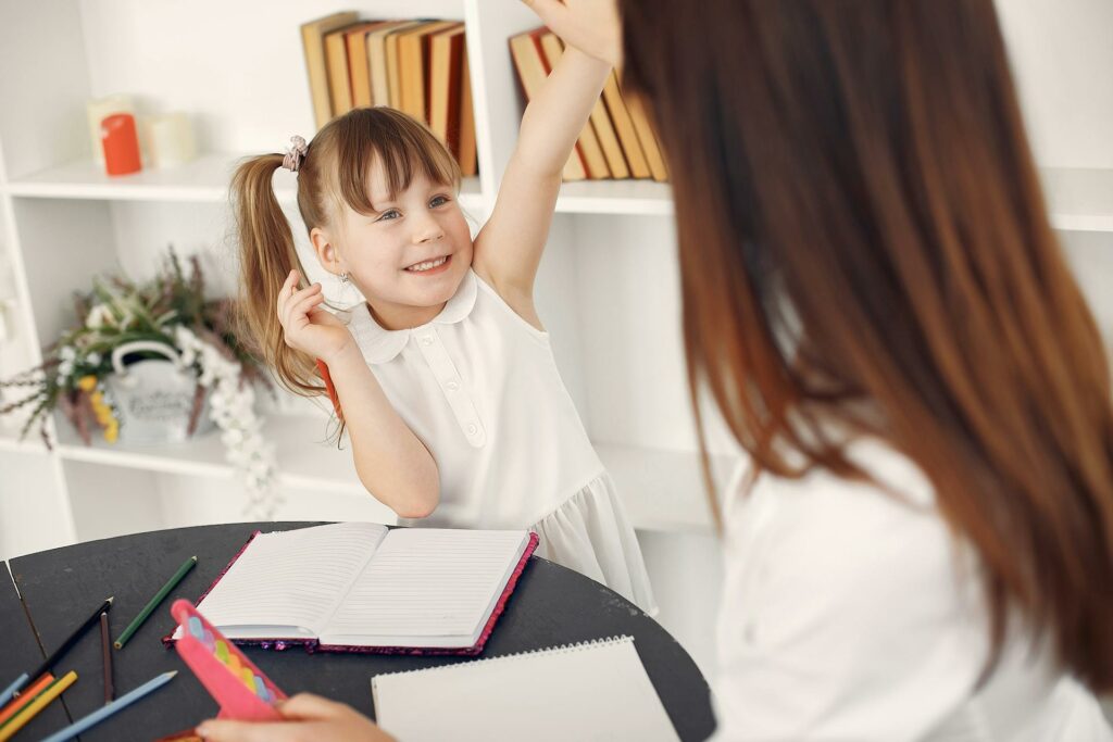 A child receiving positive reinforcement, a vital part of lessons at home